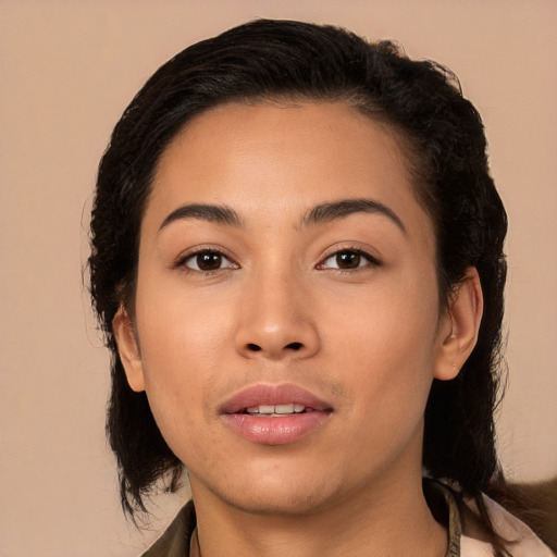 Joyful latino young-adult female with medium  brown hair and brown eyes