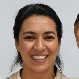 Joyful asian young-adult female with medium  black hair and brown eyes