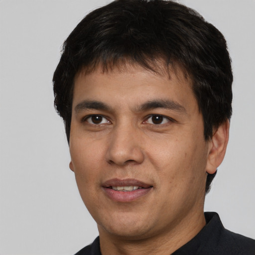 Joyful white young-adult male with short  black hair and brown eyes