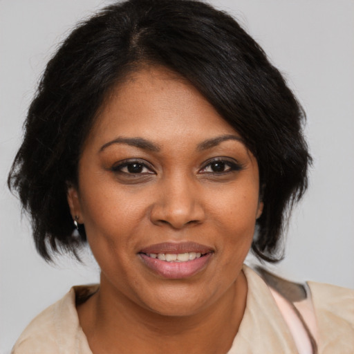 Joyful black young-adult female with medium  brown hair and brown eyes