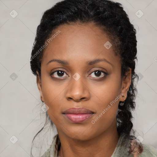 Joyful black young-adult female with long  black hair and brown eyes