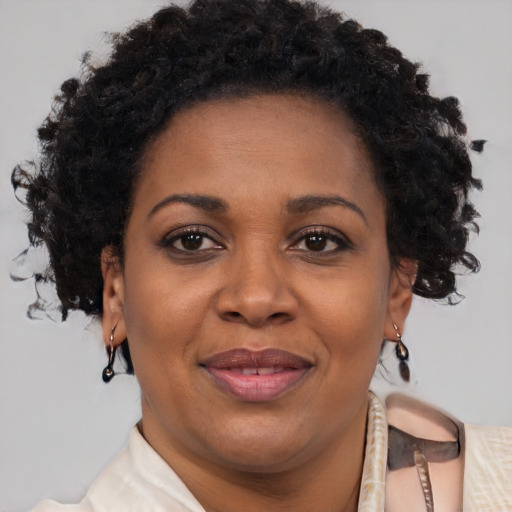 Joyful black adult female with short  brown hair and brown eyes