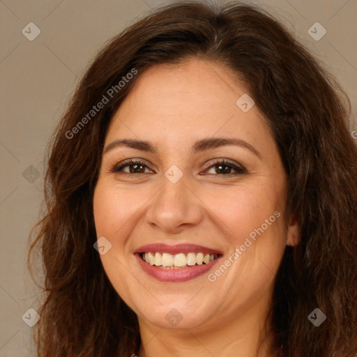 Joyful white adult female with long  brown hair and brown eyes