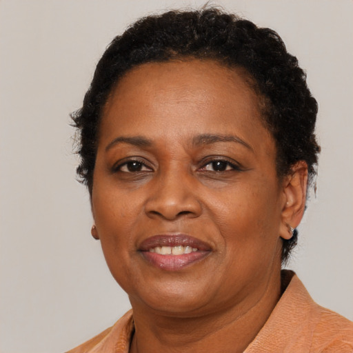 Joyful black adult female with short  brown hair and brown eyes