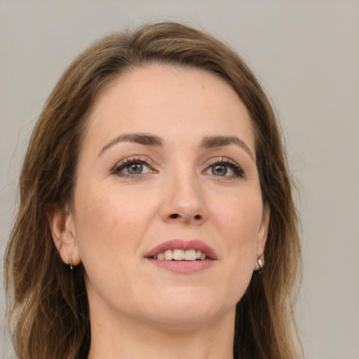 Joyful white young-adult female with long  brown hair and green eyes