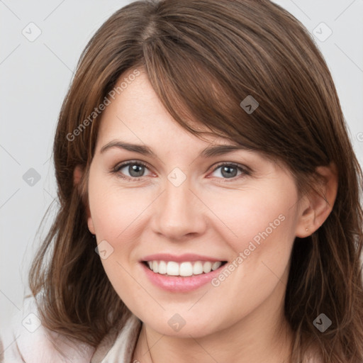 Joyful white young-adult female with medium  brown hair and grey eyes