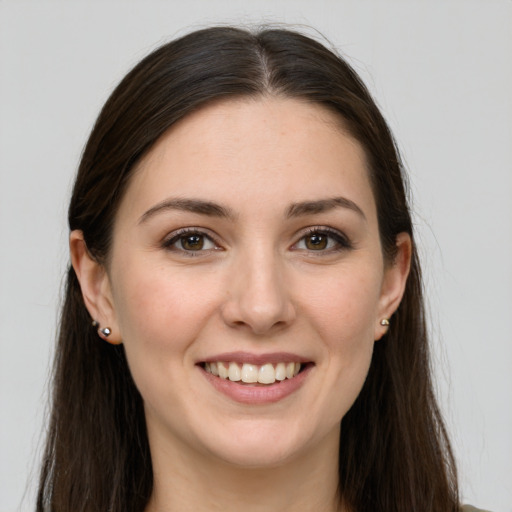 Joyful white young-adult female with long  brown hair and grey eyes