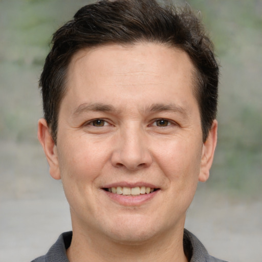 Joyful white adult male with short  brown hair and brown eyes