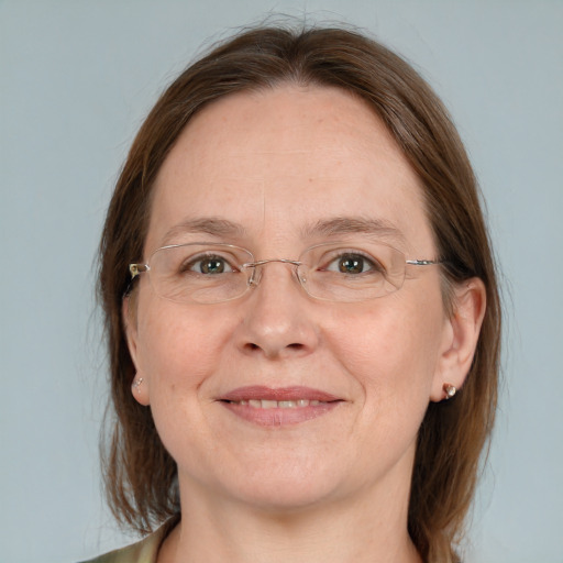 Joyful white adult female with medium  brown hair and grey eyes