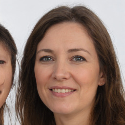 Joyful white adult female with long  brown hair and brown eyes