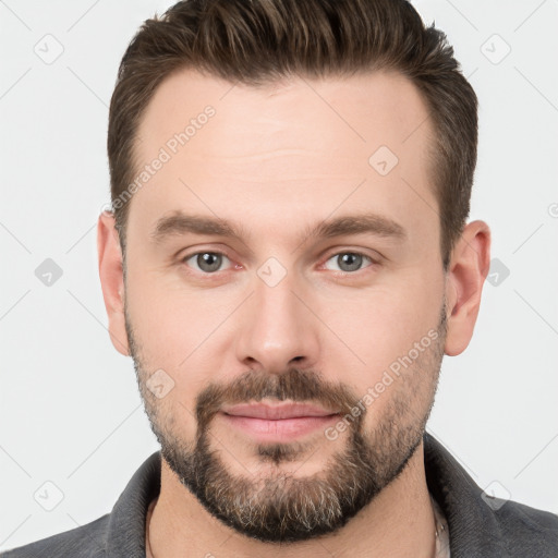 Joyful white young-adult male with short  brown hair and brown eyes