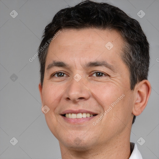 Joyful white adult male with short  brown hair and brown eyes