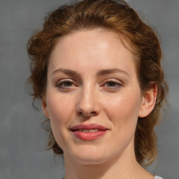 Joyful white young-adult female with medium  brown hair and blue eyes