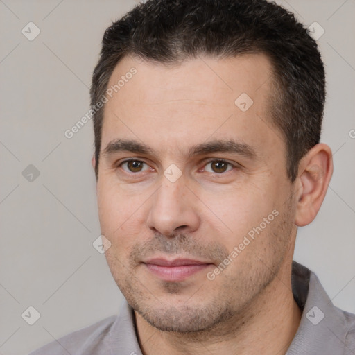 Joyful white adult male with short  brown hair and brown eyes