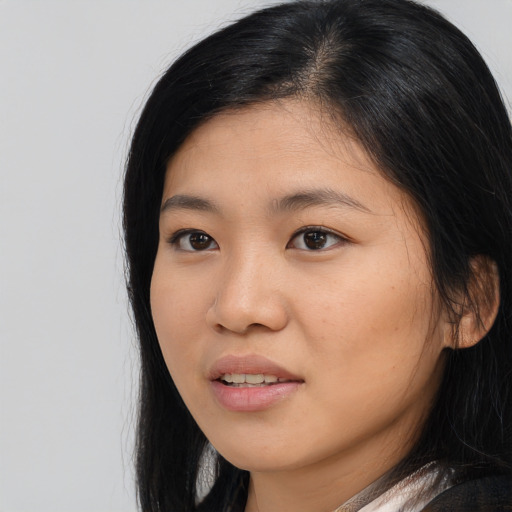 Joyful asian young-adult female with long  black hair and brown eyes