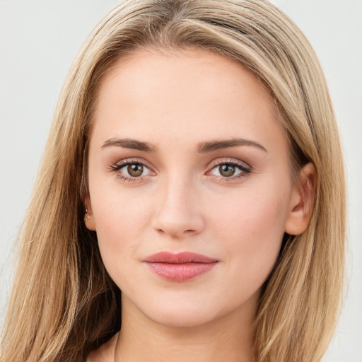 Joyful white young-adult female with long  brown hair and green eyes