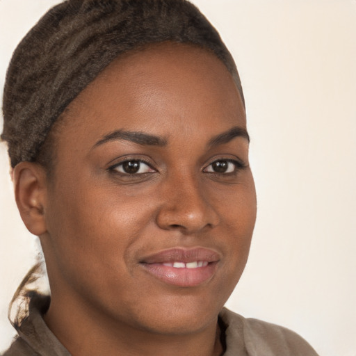 Joyful black young-adult female with short  brown hair and brown eyes