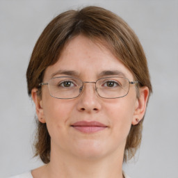 Joyful white adult female with medium  brown hair and grey eyes