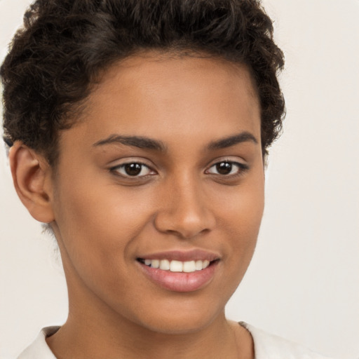 Joyful latino young-adult female with short  brown hair and brown eyes