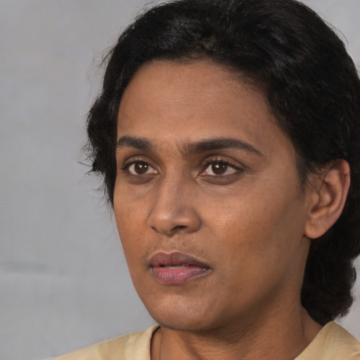 Neutral white adult female with short  black hair and brown eyes