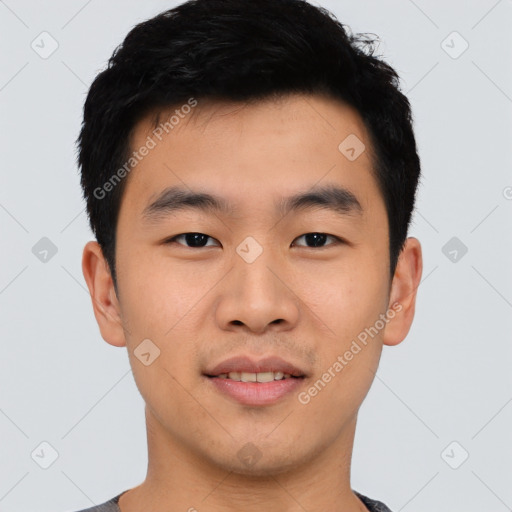 Joyful asian young-adult male with short  black hair and brown eyes