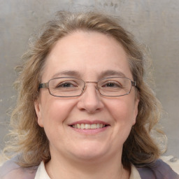 Joyful white adult female with medium  brown hair and blue eyes