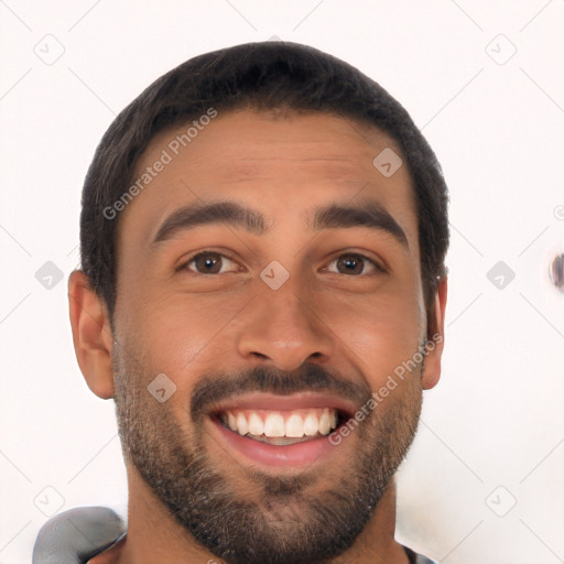 Joyful latino young-adult male with short  black hair and brown eyes