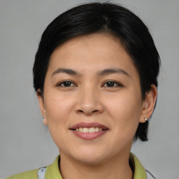 Joyful asian young-adult female with medium  brown hair and brown eyes