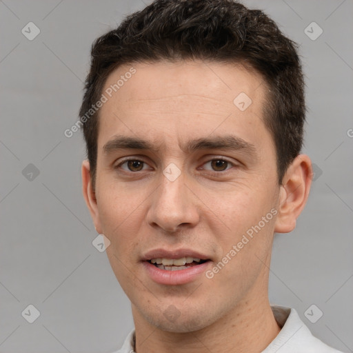 Joyful white young-adult male with short  brown hair and brown eyes