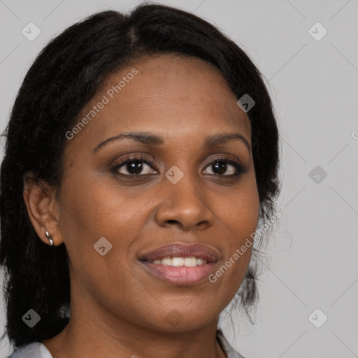 Joyful black young-adult female with long  brown hair and brown eyes