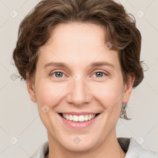 Joyful white young-adult female with short  brown hair and grey eyes