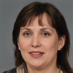 Joyful white adult female with medium  brown hair and brown eyes