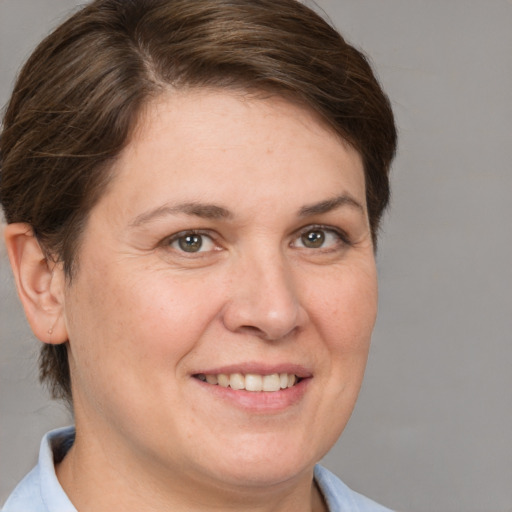 Joyful white adult female with short  brown hair and brown eyes