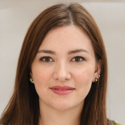 Joyful white young-adult female with long  brown hair and green eyes