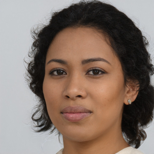 Joyful latino young-adult female with medium  brown hair and brown eyes