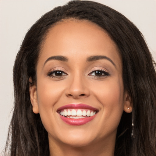 Joyful white young-adult female with long  brown hair and brown eyes