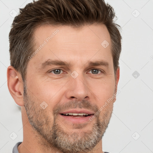 Joyful white adult male with short  brown hair and brown eyes