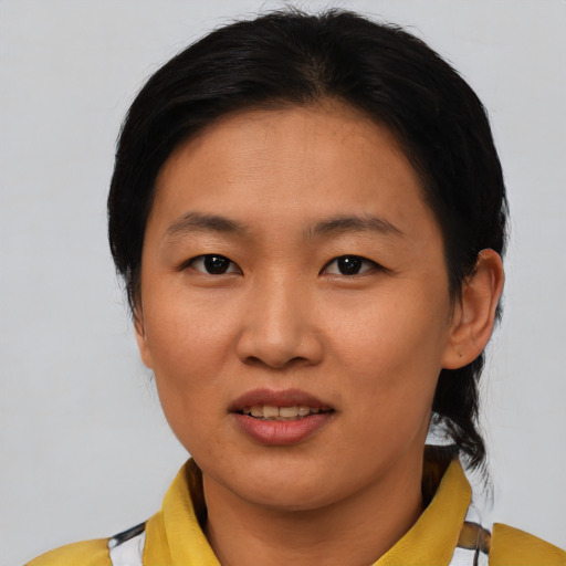 Joyful asian young-adult female with medium  black hair and brown eyes