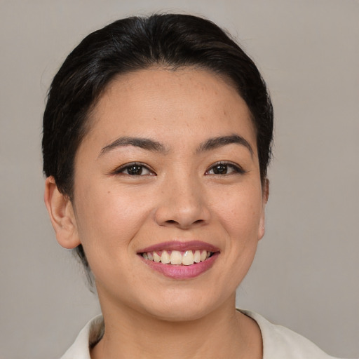 Joyful asian young-adult female with short  brown hair and brown eyes