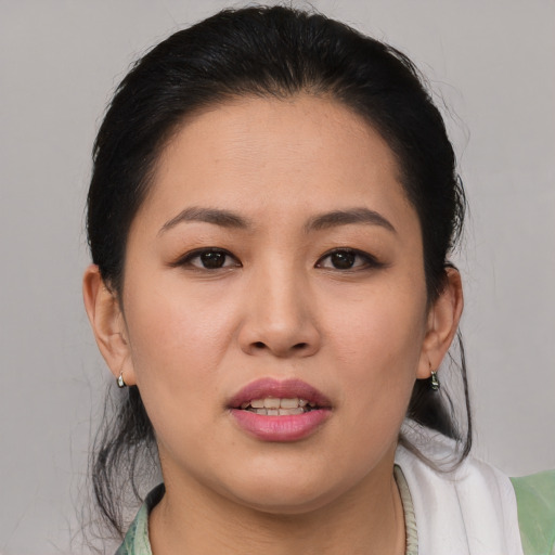Joyful asian young-adult female with medium  brown hair and brown eyes