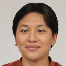 Joyful asian young-adult female with short  brown hair and brown eyes