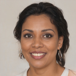 Joyful black adult female with medium  brown hair and brown eyes