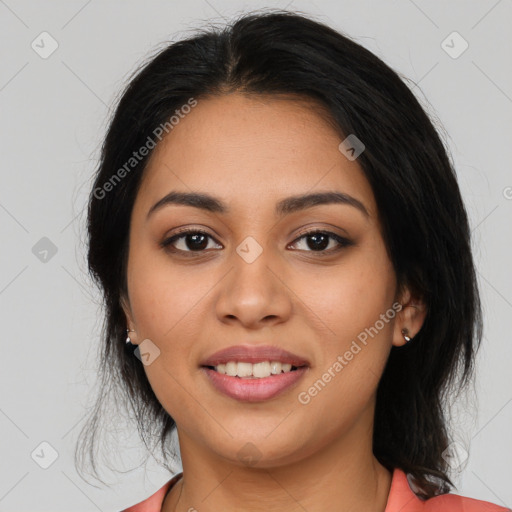 Joyful latino young-adult female with long  black hair and brown eyes