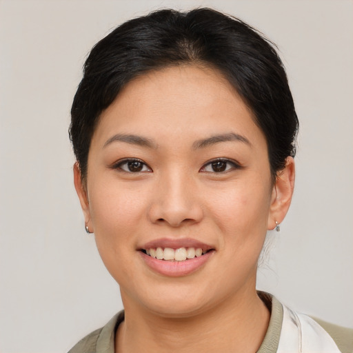 Joyful asian young-adult female with short  brown hair and brown eyes