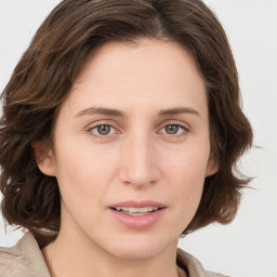 Joyful white young-adult female with medium  brown hair and blue eyes