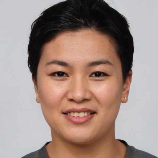 Joyful asian young-adult female with short  brown hair and brown eyes