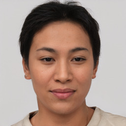 Joyful asian young-adult female with short  brown hair and brown eyes