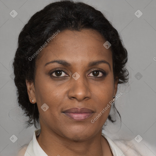 Joyful black adult female with medium  brown hair and brown eyes