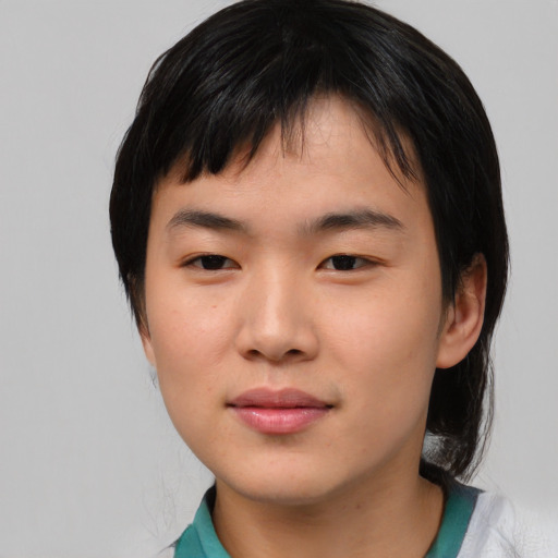 Joyful asian young-adult male with medium  black hair and brown eyes