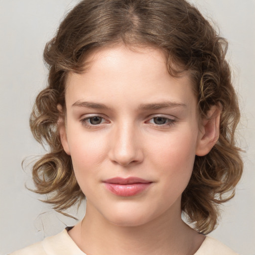 Joyful white child female with medium  brown hair and brown eyes